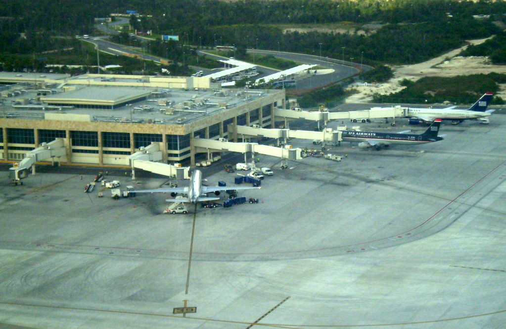 Cancun International Airport terminal building under a bright sky